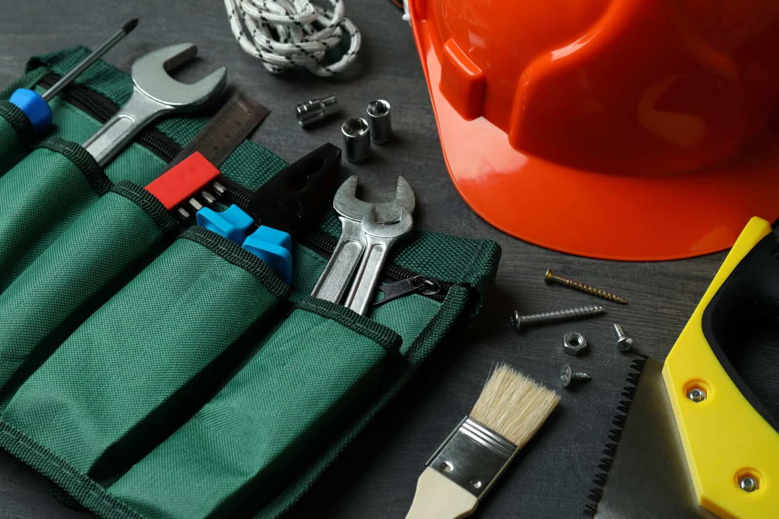 Concept of Labor Day with different construction tools on dark wooden background